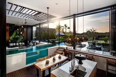 a villa with a swimming pool and a house at Villa Australis in Kerobokan