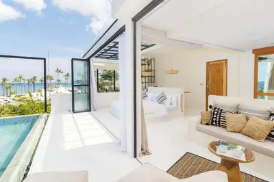a villa with a pool and a bedroom at White Goose Boutique Hotel in Canggu