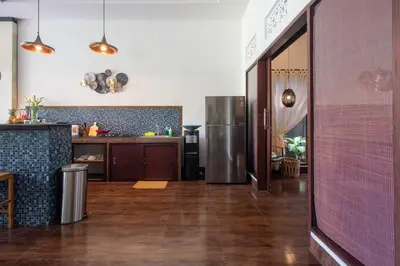 a kitchen with a refrigerator and a counter top at CASA PINARAK 1 I 3BR Private Villa near Seminyak in Seminyak