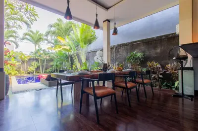 a dining room with a table and chairs and a large window at CASA PINARAK 1 I 3BR Private Villa near Seminyak in Seminyak