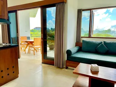 a living room with a couch and a table at Bali Karma Sajtra Hotel in Seminyak