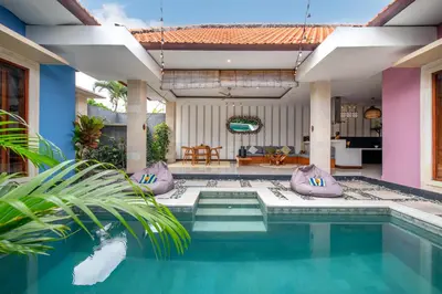a swimming pool in a villa with a house at VILLA SCARLET in Seminyak