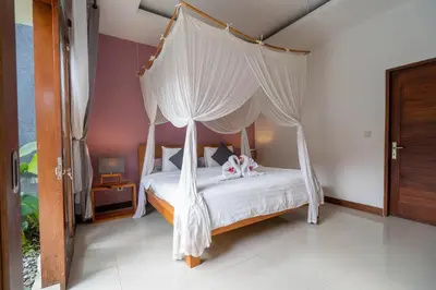 a bedroom with a bed with a canopy at VILLA SCARLET in Seminyak