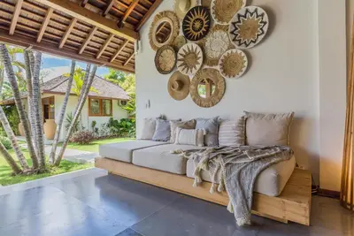 a living room with a couch and plates on the wall at Villa B in Seminyak