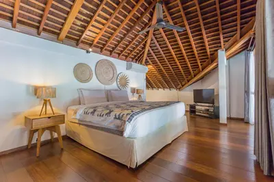 a bedroom with a bed and a ceiling fan at Villa B in Seminyak