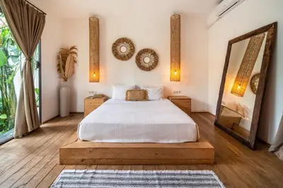 a bedroom with a bed and a large mirror at Villa Hatari Canggu in Kerobokan