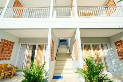 a staircase leading to the second floor of a house at Dharma Guest House Seminyak RedPartner in Seminyak