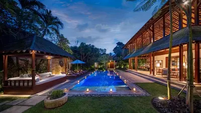 an exterior view of a villa with a swimming pool at Villa Windu Sari in Seminyak