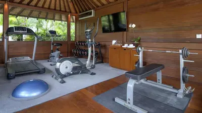 a gym with exercise equipment in a room at Villa Windu Sari in Seminyak