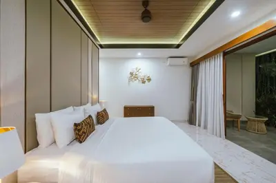 a bedroom with a large white bed in a room at Villa Reillo Canggu in Canggu
