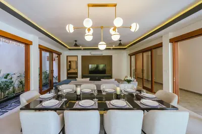 a dining room with a table and chairs at Villa Reillo Canggu in Canggu