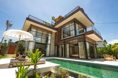 a house with a swimming pool in front of it at Villa Kamal Umalas in Kerobokan