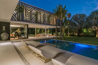 an exterior view of a house with a swimming pool at Villa Bull House Amazing 6 bedrooms contemporary villa in Seminyak in Seminyak