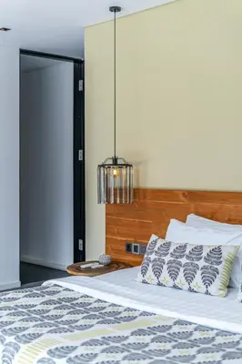 a bedroom with a bed with a chandelier above it at Villa Bull House Amazing 6 bedrooms contemporary villa in Seminyak in Seminyak