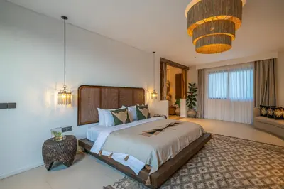 a bedroom with a large bed and a couch at Villa Bull House Amazing 6 bedrooms contemporary villa in Seminyak in Seminyak
