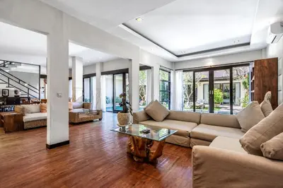 a living room with a couch and a table at Anedda Merta Sari Villa Sanur in Sanur
