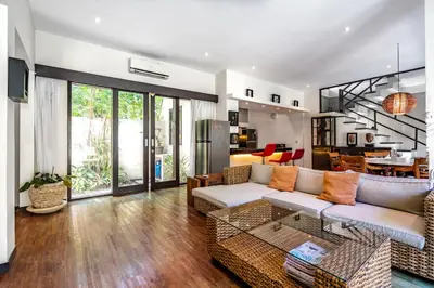 a living room with a couch and a table at Anedda Merta Sari Villa Sanur in Sanur