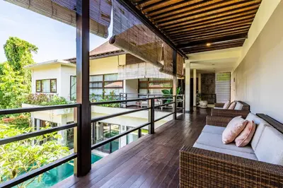 an open balcony with a view of a house at Anedda Merta Sari Villa Sanur in Sanur