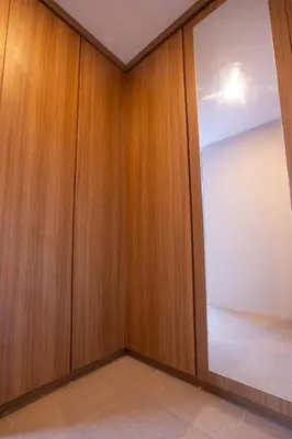 a room with wooden walls and a sliding door at Lacrissa Bali in Kerobokan
