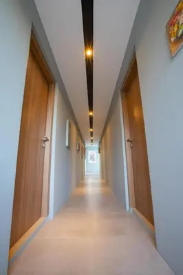 a hallway of an office building with wooden doors at Lacrissa Bali in Kerobokan
