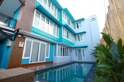 a building with a swimming pool in front of it at Lacrissa Bali in Kerobokan