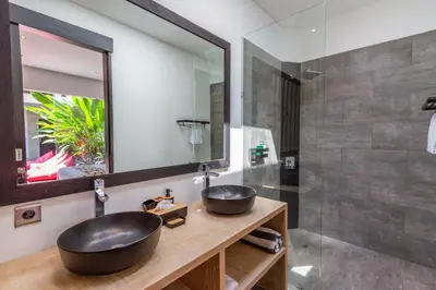 a bathroom with a sink and a mirror at Villa Lys by Alfred in Bali in Canggu