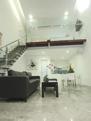 a living room with a couch and a staircase at Bali Yarra Villas - Seminyak in Seminyak