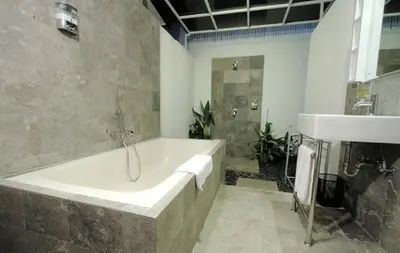 a bathroom with a bath tub and a sink at Bali Yarra Villas - Seminyak in Seminyak