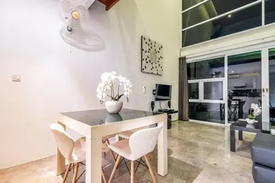 a dining room with a table and chairs at Bali Yarra Villas - Seminyak in Seminyak