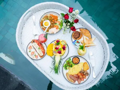 a white table with plates of food on it at Samaja Villas Seminyak in Seminyak