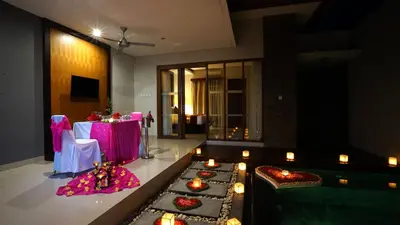 a room with a table with candles and some lights at Samaja Villas Seminyak in Seminyak