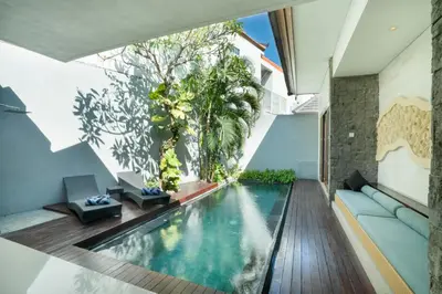 an infinity pool in the middle of a house at Samaja Villas Seminyak in Seminyak