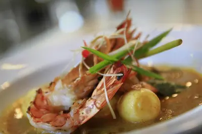 a plate of food with a shrimp in a soup at Mars City Hotel in Denpasar