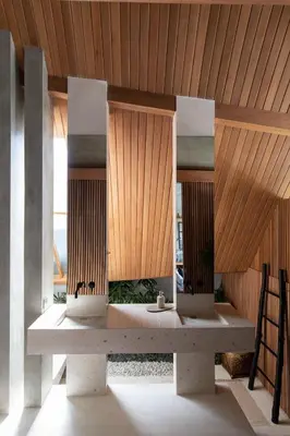 a bench in a room with a wooden ceiling at Beyond Bayou in Seminyak