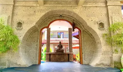 a statue in an archway in a building at Villa Naga Maya in Legian