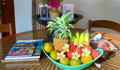 a bowl of fruit on a table with a magazine at Villa Naga Maya in Legian