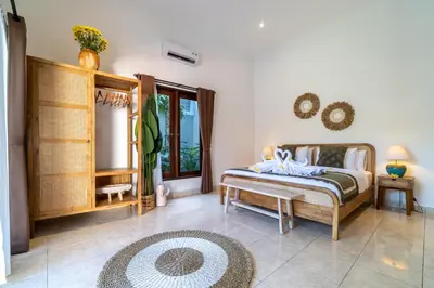a bedroom with a bed and a window at CASA MALEH 2BR lively villa in kayuaya seminyak in Seminyak
