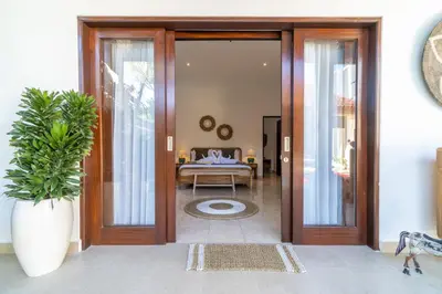 a door leading into a living room with a table at CASA MALEH 2BR lively villa in kayuaya seminyak in Seminyak
