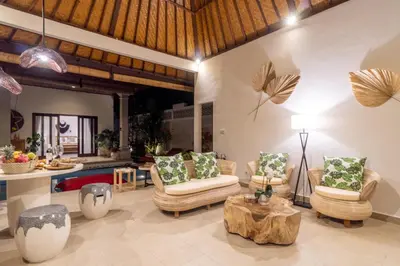 a living room with two chairs and a table at CASA MALEH 2BR lively villa in kayuaya seminyak in Seminyak