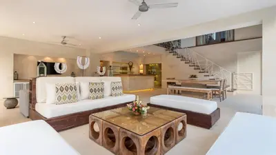 a living room with a white couch and a table at Casa Mateo Villa in Seminyak