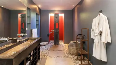a bathroom with a large sink and a large mirror at Casa Mateo Villa in Seminyak