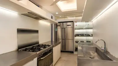 a kitchen with a stove and a sink at Casa Mateo Villa in Seminyak