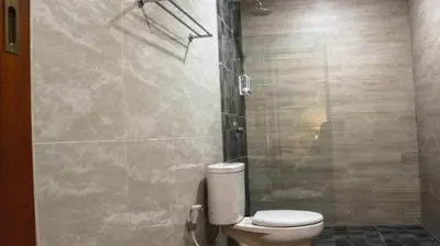 a bathroom with a toilet and a shower at Kubu De Uma in Seminyak