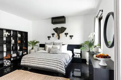 a bedroom with a bed and a mirror at Villa Anaya Manis in Seminyak