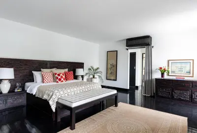 a bedroom with a large bed with red pillows at Villa Anaya Manis in Seminyak