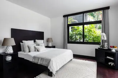 a bedroom with a large bed and a window at Villa Anaya Manis in Seminyak