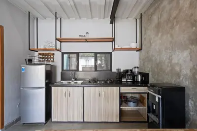 a kitchen with a sink and a refrigerator at Jaci Residence by Betterplace in Canggu