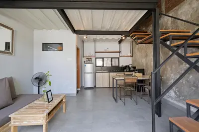 an open living room with a kitchen and dining room at Jaci Residence by Betterplace in Canggu