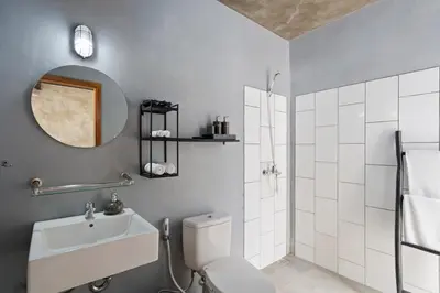 a bathroom with a toilet and a sink and a mirror at Jaci Residence by Betterplace in Canggu