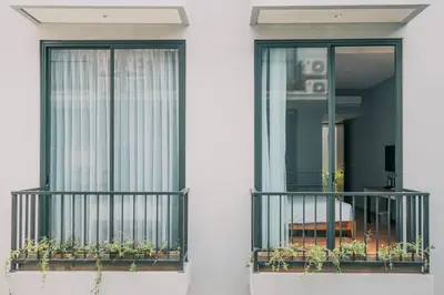 a balcony with a window with plants on it at Bestah Coliving in Sanur